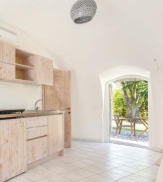 Bright kitchen with light wood furniture and garden view.